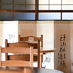 書の作品が飾られた窓際テーブル席